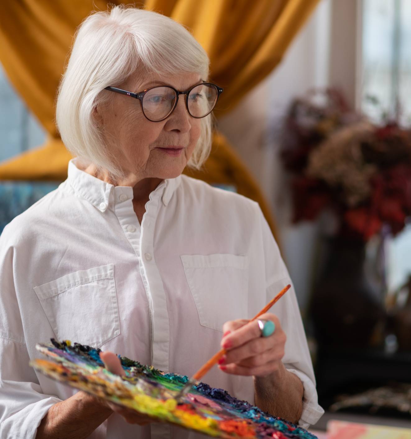 Resident enjoying a quiet moment reading in a comfortable, light-filled living space
